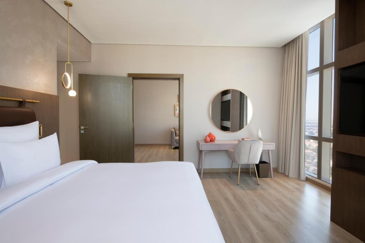 Movenpick Jumeirah Village Triangle Дубай Экстерьер фото A bedroom at the hotel
