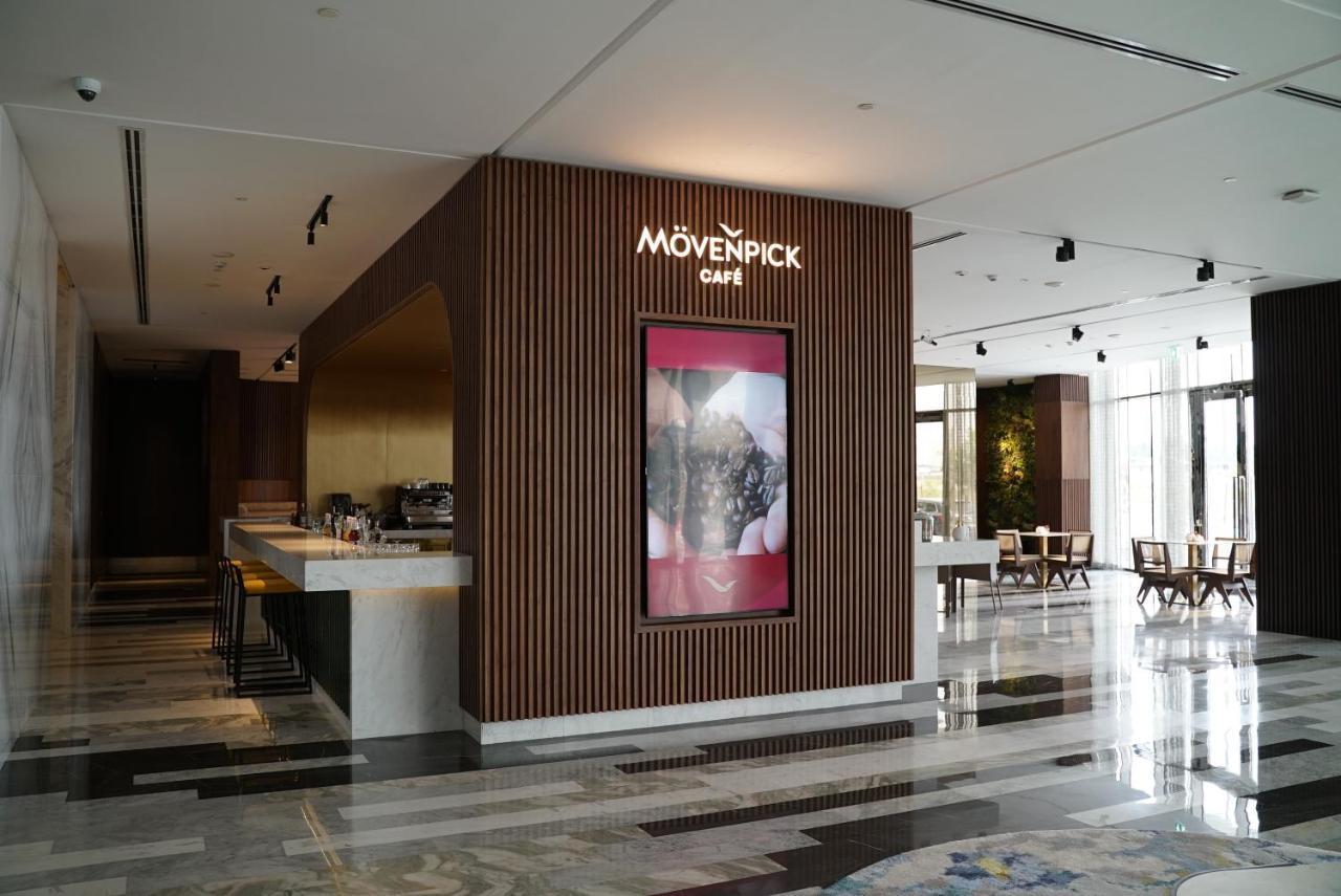 Movenpick Jumeirah Village Triangle Дубай Экстерьер фото Mövenpick Café in the lobby of the Kempinski Hotel, Amman, Jordan
